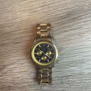 Women’s gold watch with navy color face. Used in good condition.